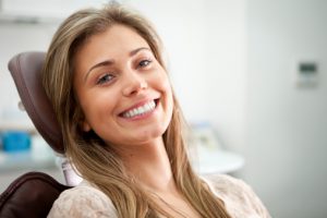 Woman at dentist considers periodontal treatment.